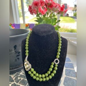 Vintage spinach green acrylic beads with silver-tone leaf with rhinestones.